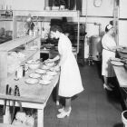 Cafeteria workers preparing lunch in the kitchen.